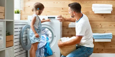 Vater und Tochter waschen gemeinsam die Wäsche